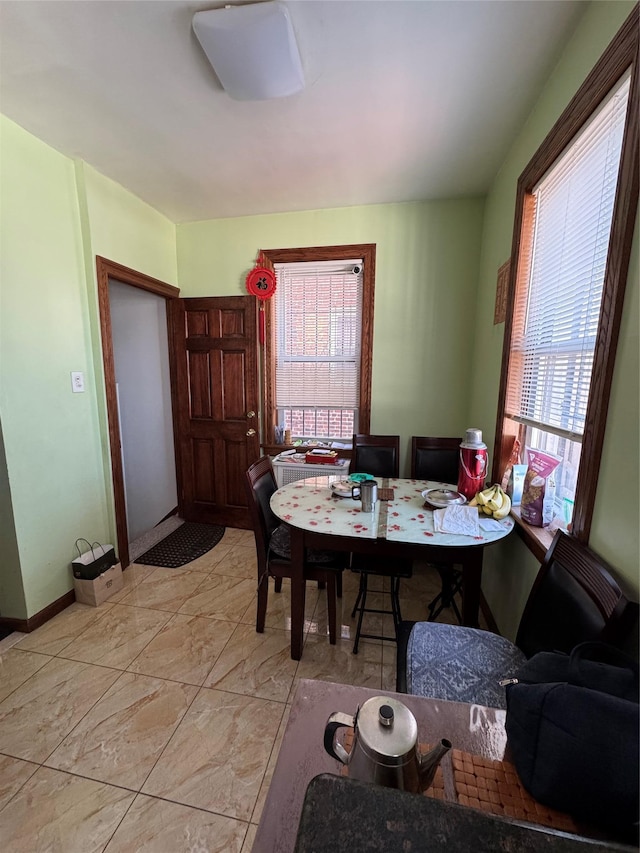 59-32 163rd St, Fresh Meadows, NY 11365 - dining room with healthy amount of natural light, light marble finish floors, and baseboards