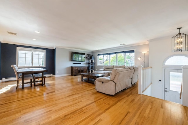 2033 Waltoffer Ave, North Bellmore, NY 11710 - living area featuring light wood-type flooring, ornamental molding, a chandelier, a baseboard radiator, and baseboards