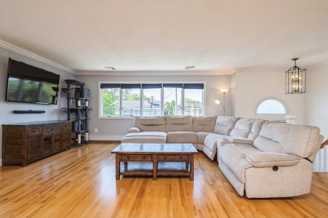 2033 Waltoffer Ave, North Bellmore, NY 11710 - living room with a chandelier, light wood-style floors, crown molding, and baseboards