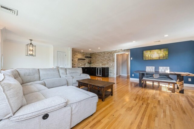 2033 Waltoffer Ave, North Bellmore, NY 11710 - living area featuring a chandelier, light wood-style floors, crown molding, recessed lighting, and baseboards