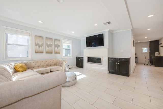 2033 Waltoffer Ave, North Bellmore, NY 11710 - living room with ornamental molding, a glass covered fireplace, recessed lighting, baseboards, and light tile patterned flooring