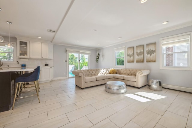2033 Waltoffer Ave, North Bellmore, NY 11710 - living room with crown molding, recessed lighting, a baseboard radiator, and baseboards