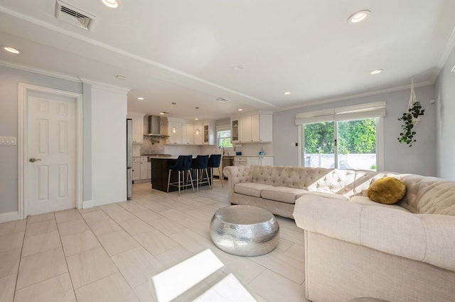 2033 Waltoffer Ave, North Bellmore, NY 11710 - living room featuring recessed lighting, ornamental molding, and light tile patterned floors