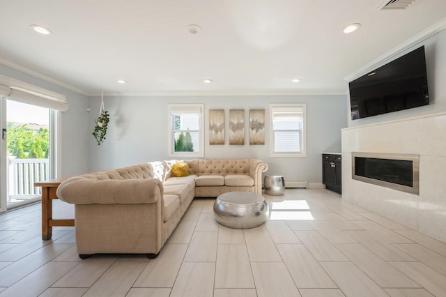 2033 Waltoffer Ave, North Bellmore, NY 11710 - living room with healthy amount of natural light, ornamental molding, recessed lighting, a glass covered fireplace, and baseboards