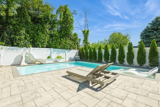 2033 Waltoffer Ave, North Bellmore, NY 11710 - view of pool featuring a water slide, a fenced backyard, and a patio