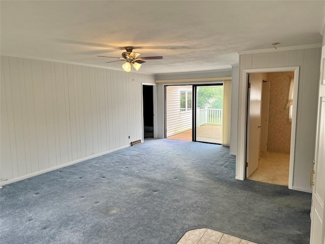 50 Mills Pond Rd, Saint James, NY 11780 - spare room featuring carpet floors, ceiling fan, ornamental molding, and wood walls