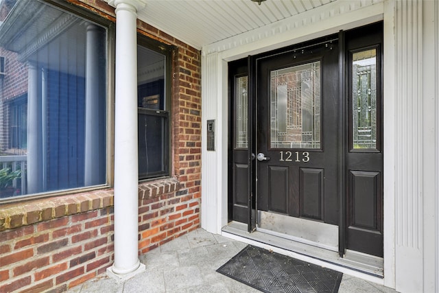 1213 E Broadway Unit B25, Hewlett, NY 11557 - doorway to property with brick siding and a porch