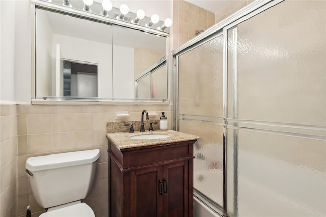 1213 E Broadway Unit B25, Hewlett, NY 11557 - bathroom with tile walls, toilet, vanity, and enclosed tub / shower combo