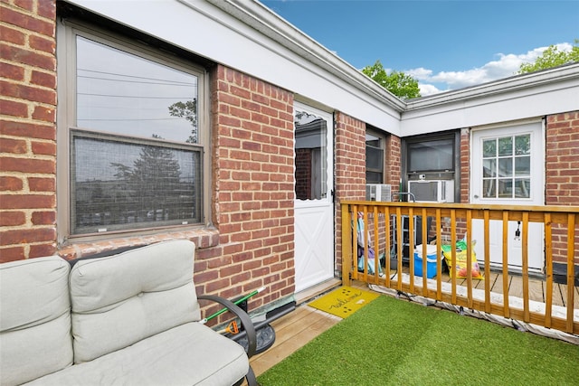 1213 E Broadway Unit B25, Hewlett, NY 11557 - property entrance featuring brick siding and a deck