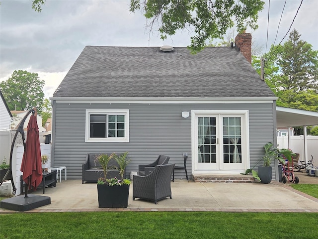 980 Alhambra Rd, North Baldwin, NY 11510 - rear view of property featuring roof with shingles, a chimney, a patio area, and an outdoor hangout area