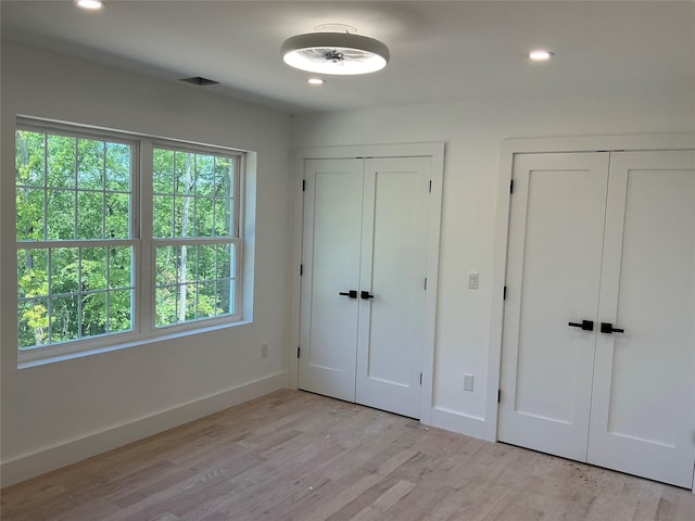 26 Rodina Dr, Pawling, NY 12564 - unfurnished bedroom with two closets, baseboards, light wood finished floors, and recessed lighting