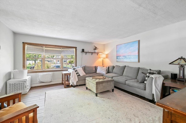 8 Meyer Ln, Medford, NY 11763 - living area featuring a textured ceiling, baseboard heating, and wood finished floors