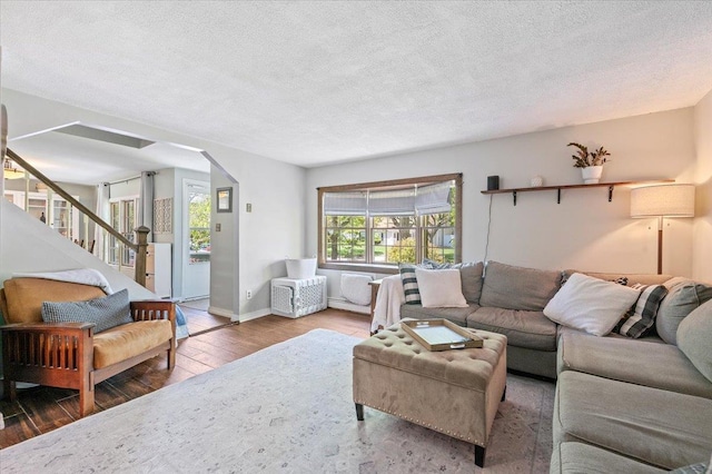 8 Meyer Ln, Medford, NY 11763 - living area with hardwood / wood-style flooring, a textured ceiling, arched walkways, stairway, and baseboards