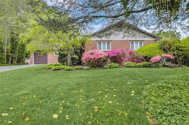 29 Cross Bow Ln, Commack, NY 11725 - view of front facade featuring a garage, a front yard, brick siding, and driveway
