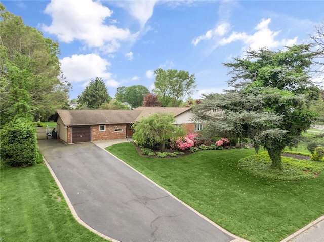 29 Cross Bow Ln, Commack, NY 11725 - view of front of home featuring an attached garage, brick siding, driveway, and a front yard