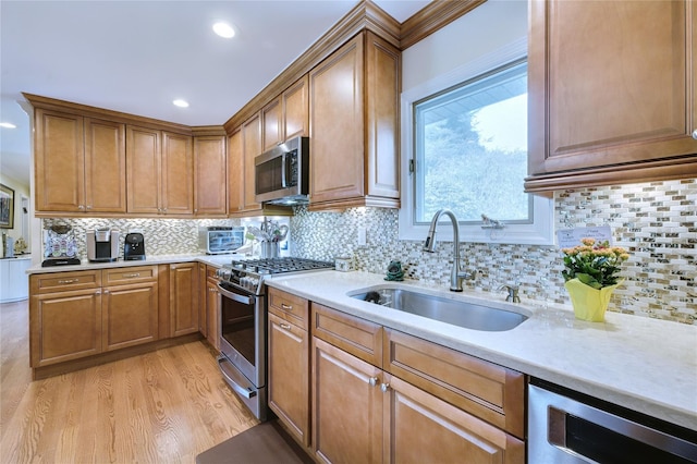 29 Cross Bow Ln, Commack, NY 11725 - kitchen featuring stainless steel appliances, a sink, light wood-type flooring, light countertops, and brown cabinetry