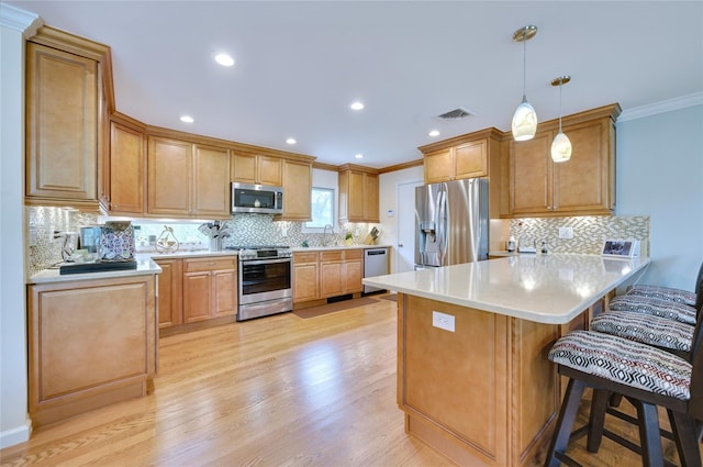 29 Cross Bow Ln, Commack, NY 11725 - kitchen with stainless steel appliances, a peninsula, crown molding, a sink, and a kitchen breakfast bar