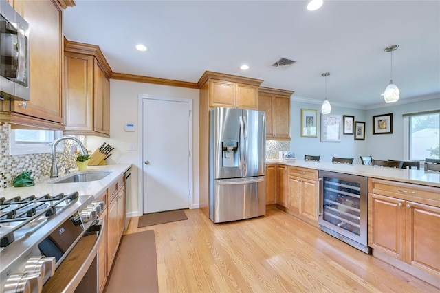 29 Cross Bow Ln, Commack, NY 11725 - kitchen with stainless steel appliances, beverage cooler, a sink, light wood-type flooring, and light countertops