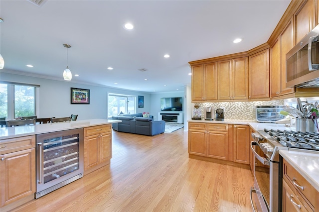 29 Cross Bow Ln, Commack, NY 11725 - kitchen with wine cooler, appliances with stainless steel finishes, crown molding, light countertops, and light wood-type flooring