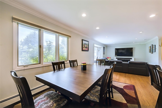 29 Cross Bow Ln, Commack, NY 11725 - dining area featuring light wood-style flooring, recessed lighting, crown molding, baseboard heating, and a baseboard heating unit
