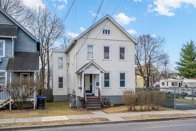 view of front of house featuring fence