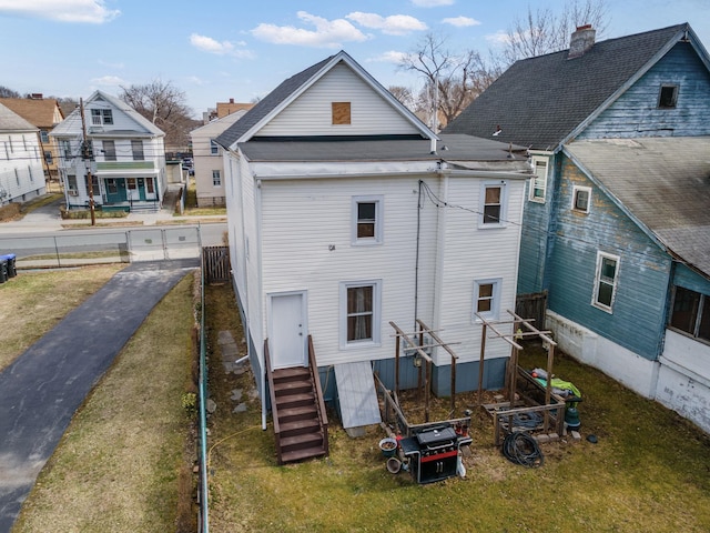 rear view of house with a residential view and entry steps