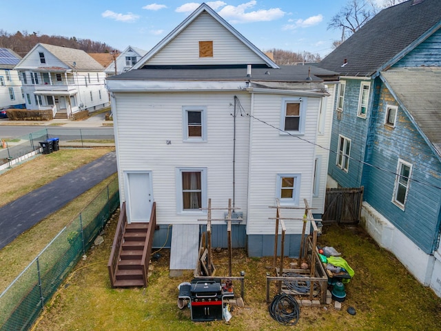 rear view of house featuring entry steps