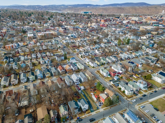 aerial view of property and surrounding area featuring a mountainous background