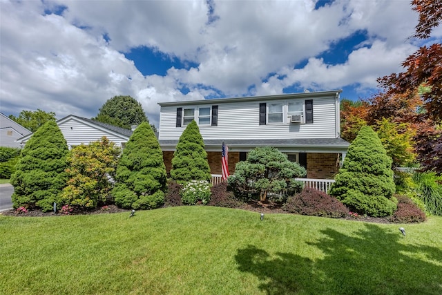 17 Daytona Beach Pl, Coram, NY 11727 - traditional-style house with a front yard, a porch, and brick siding