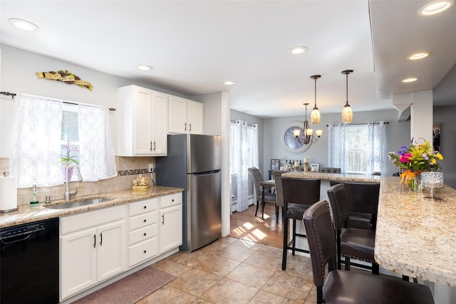 17 Daytona Beach Pl, Coram, NY 11727 - kitchen featuring black dishwasher, a sink, plenty of natural light, a baseboard radiator, and recessed lighting