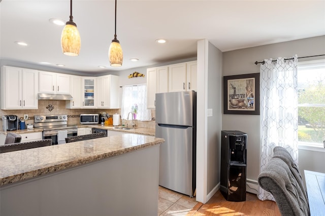 17 Daytona Beach Pl, Coram, NY 11727 - kitchen with stainless steel appliances, a sink, healthy amount of natural light, white cabinets, and recessed lighting