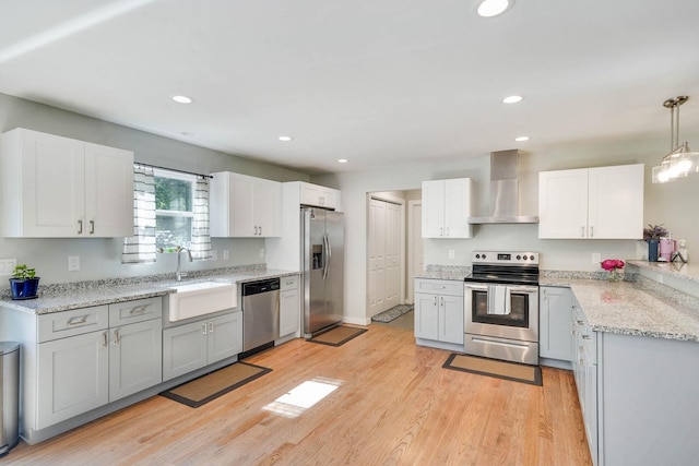 59 Middle Island Blvd, Middle Island, NY 11953 - kitchen with stainless steel appliances, wall chimney range hood, a sink, light wood finished floors, and recessed lighting