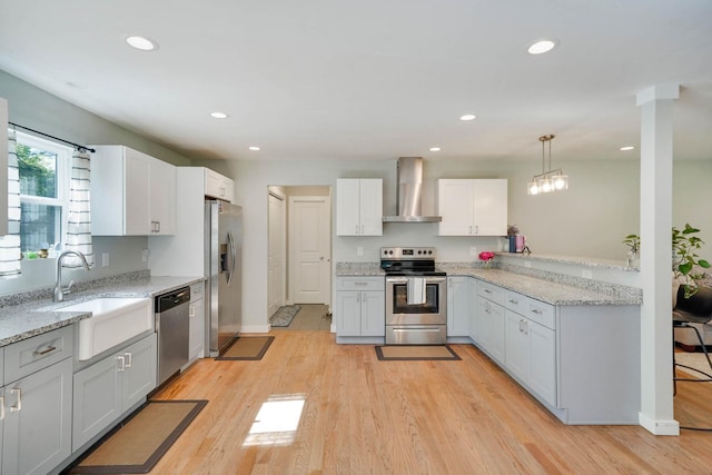 59 Middle Island Blvd, Middle Island, NY 11953 - kitchen with appliances with stainless steel finishes, wall chimney exhaust hood, recessed lighting, light wood finished floors, and a sink