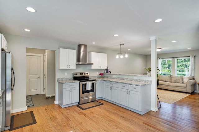 59 Middle Island Blvd, Middle Island, NY 11953 - kitchen with stainless steel appliances, wall chimney range hood, light wood-style floors, open floor plan, and recessed lighting