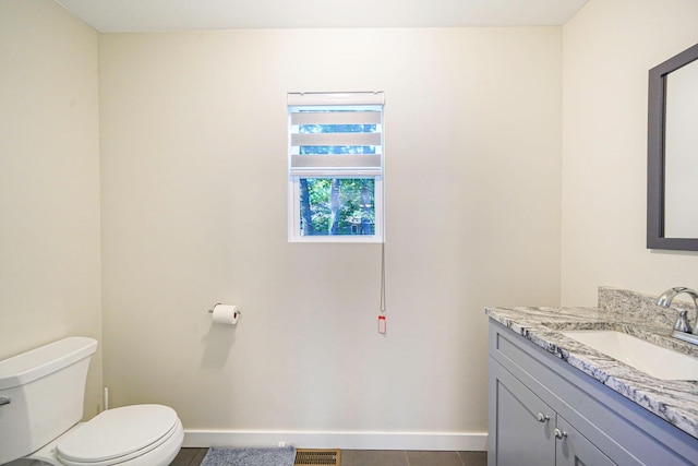 59 Middle Island Blvd, Middle Island, NY 11953 - half bathroom with toilet, vanity, baseboards, and tile patterned flooring