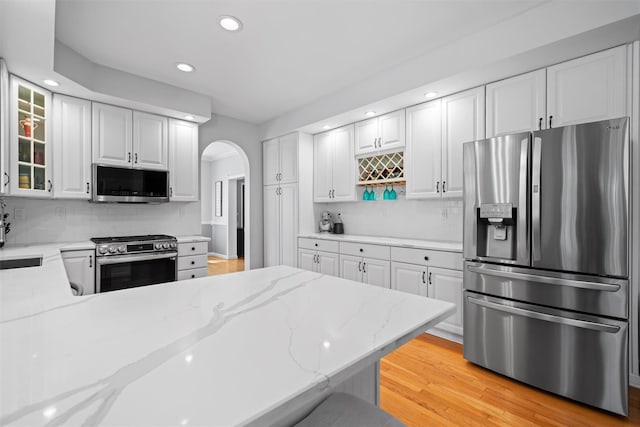 8 Roosa Rd, Wallkill, NY 12589 - kitchen featuring stainless steel appliances, arched walkways, recessed lighting, backsplash, and light stone counters