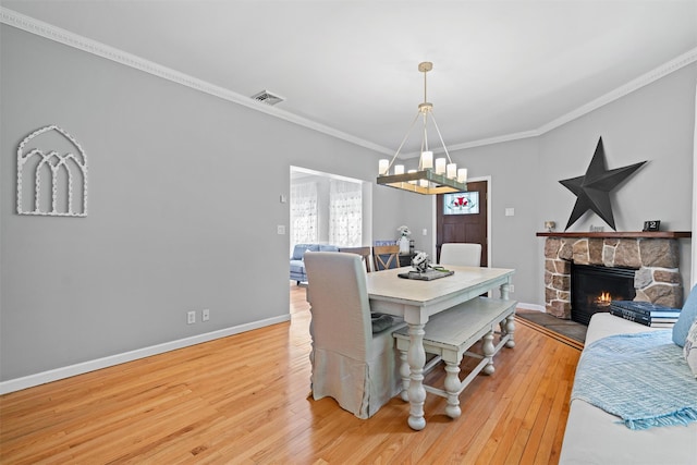 8 Roosa Rd, Wallkill, NY 12589 - dining space featuring a chandelier, wood finished floors, ornamental molding, baseboards, and a fireplace