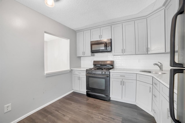 32 Huntington Cir Building 19, Peekskill, NY 10566 - kitchen with black appliances, a sink, light countertops, dark wood-type flooring, and baseboards