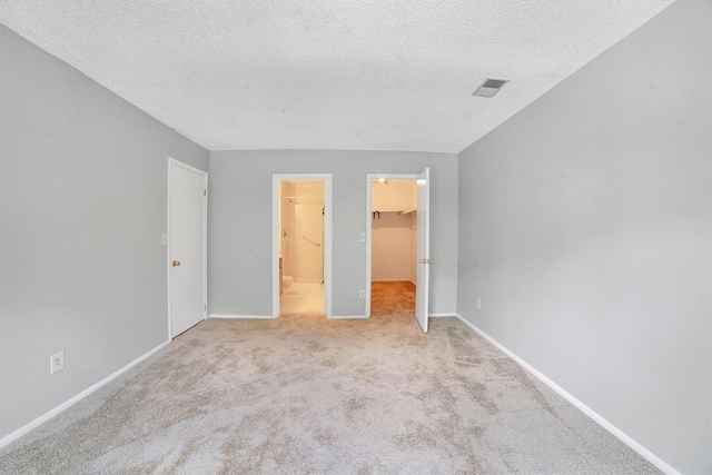32 Huntington Cir Building 19, Peekskill, NY 10566 - unfurnished bedroom with carpet floors, a spacious closet, a textured ceiling, baseboards, and a closet