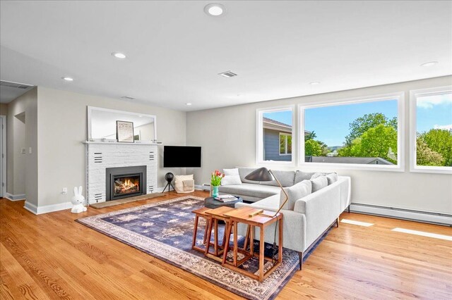 530 N Midland Ave N, Nyack, NY 10960 - living room featuring a baseboard radiator, wood finished floors, a glass covered fireplace, recessed lighting, and baseboards