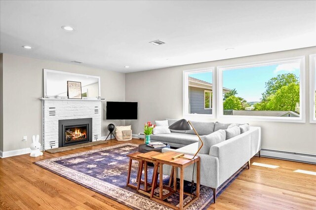 530 N Midland Ave N, Nyack, NY 10960 - living area featuring baseboard heating, a fireplace, wood finished floors, recessed lighting, and baseboards