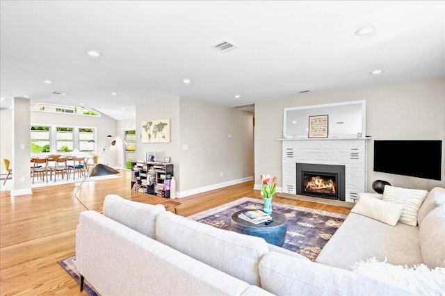 530 N Midland Ave N, Nyack, NY 10960 - living area with baseboards, wood finished floors, a fireplace with flush hearth, lofted ceiling, and recessed lighting