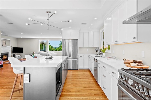 530 N Midland Ave N, Nyack, NY 10960 - kitchen featuring appliances with stainless steel finishes, under cabinet range hood, light wood-type flooring, white cabinets, and recessed lighting