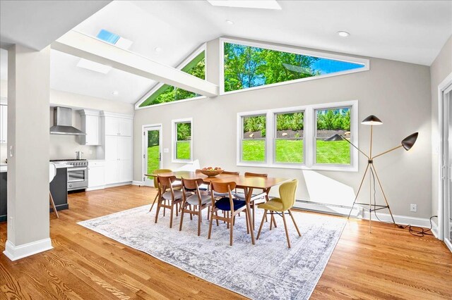 530 N Midland Ave N, Nyack, NY 10960 - dining area with a baseboard radiator, baseboards, a skylight, light wood finished floors, and high vaulted ceiling