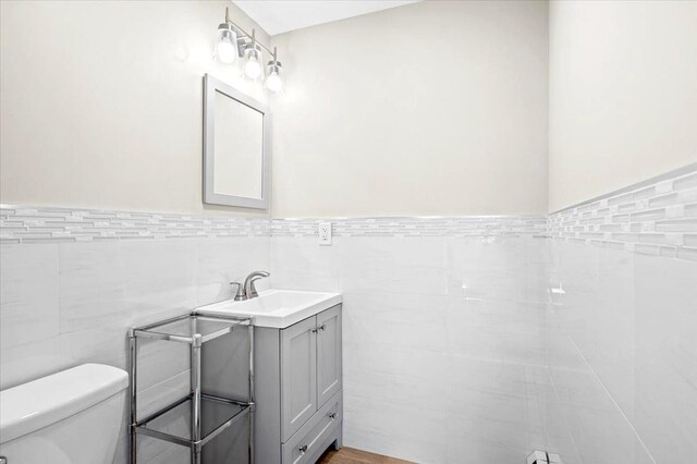 530 N Midland Ave N, Nyack, NY 10960 - half bath featuring toilet, vanity, tile walls, and wainscoting