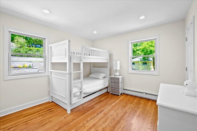 530 N Midland Ave N, Nyack, NY 10960 - bedroom with a baseboard radiator, multiple windows, light wood finished floors, recessed lighting, and baseboards