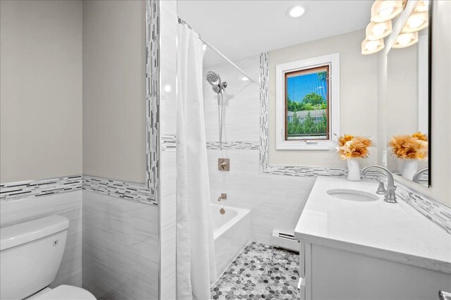 530 N Midland Ave N, Nyack, NY 10960 - bathroom with tile walls, toilet, vanity, a baseboard radiator, and shower / bath combination with curtain