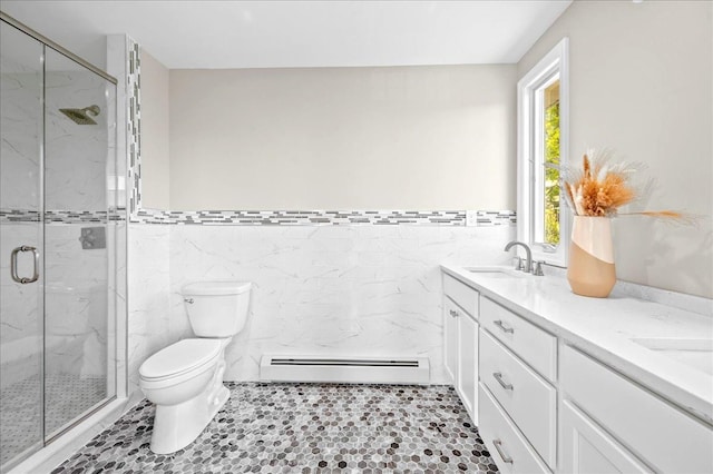 530 N Midland Ave N, Nyack, NY 10960 - full bath with a baseboard heating unit, tile walls, toilet, a marble finish shower, and double vanity