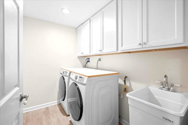 530 N Midland Ave N, Nyack, NY 10960 - laundry area featuring cabinet space, washing machine and clothes dryer, light wood-style floors, and baseboards