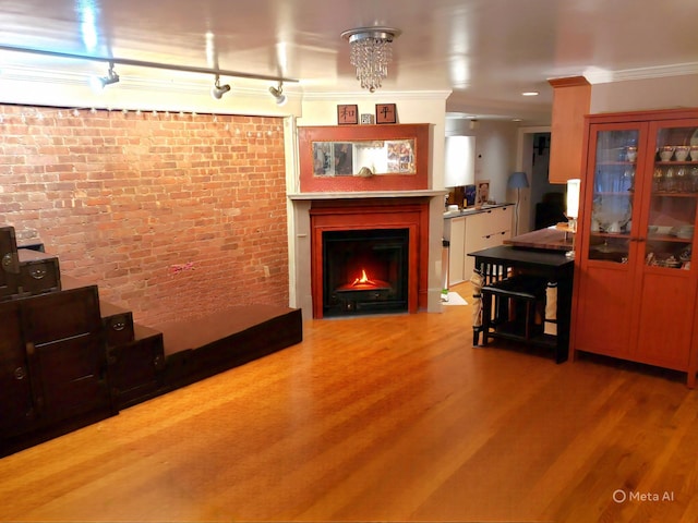 229 W 138th St, New York Manhattan, NY 10030 - living room with ornamental molding, a warm lit fireplace, wood finished floors, and brick wall